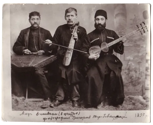 Üç Ermeni âşığın enstürmanlarıyla poz verdikleri siyah beyaz bir fotoğraf